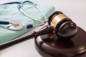 A gavel and stethoscope on a table