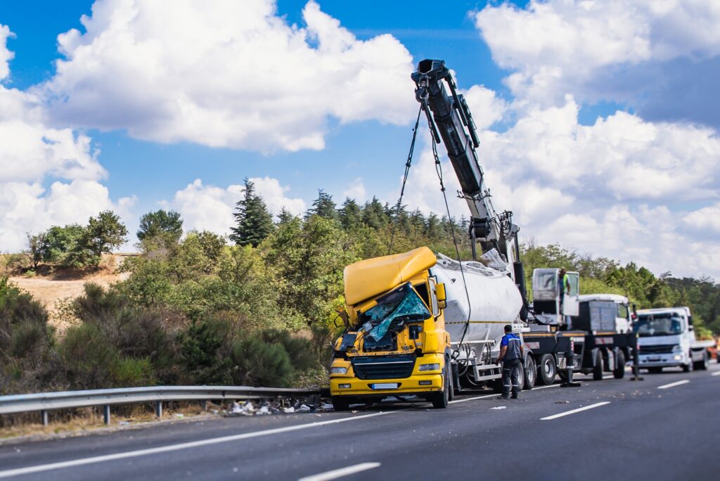 Road,Assistance.,Highway,Recovery,Of,A,Crashed,Yellow,Truck,With