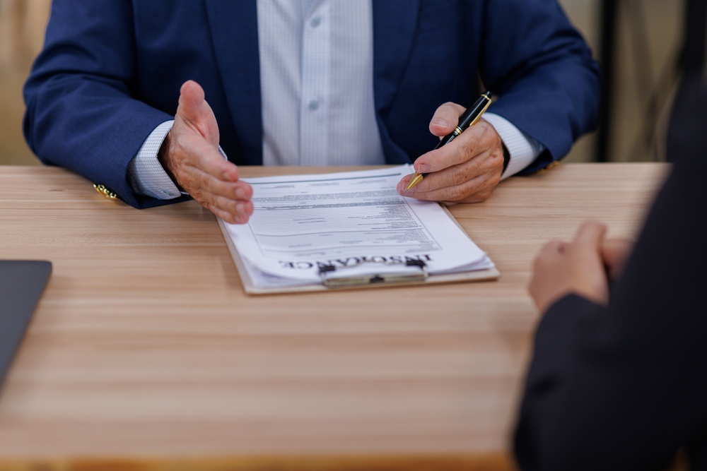 mature manager male insurance agent showing